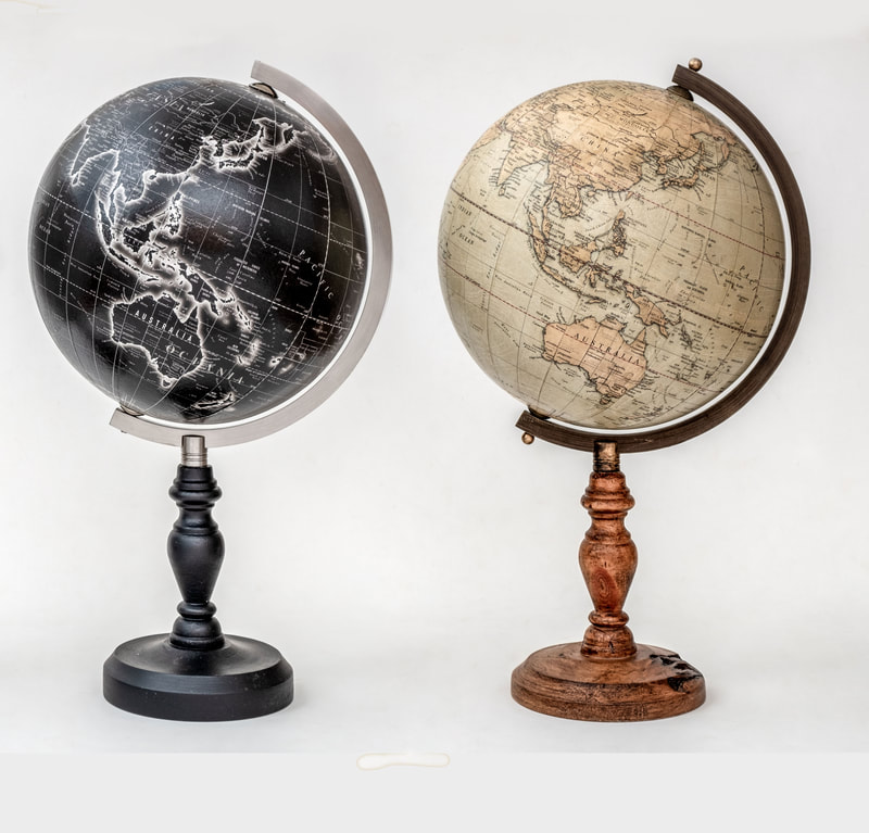 Two globes side by side, one is black and one is brown