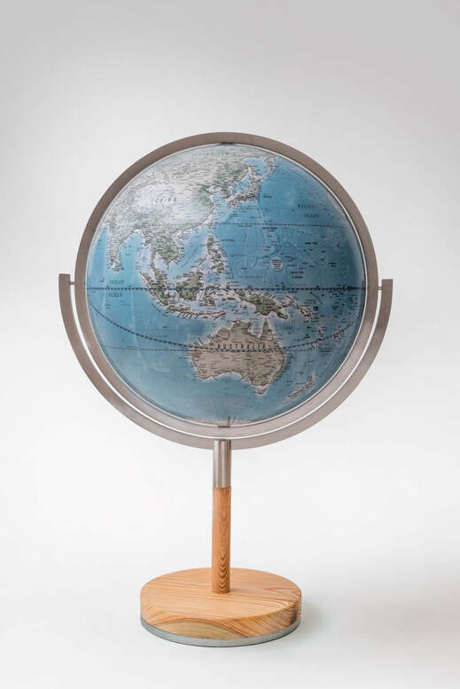 large blue globe seen from the side, showing Australia