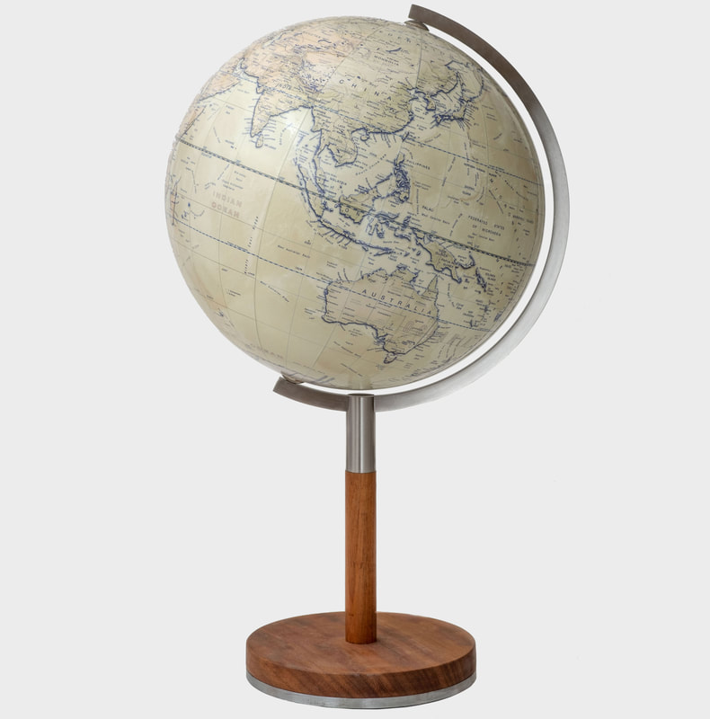 A medium sized desktop globe, lemon colour with brown landmass. a brushed steel arm and elegant hardwood stem